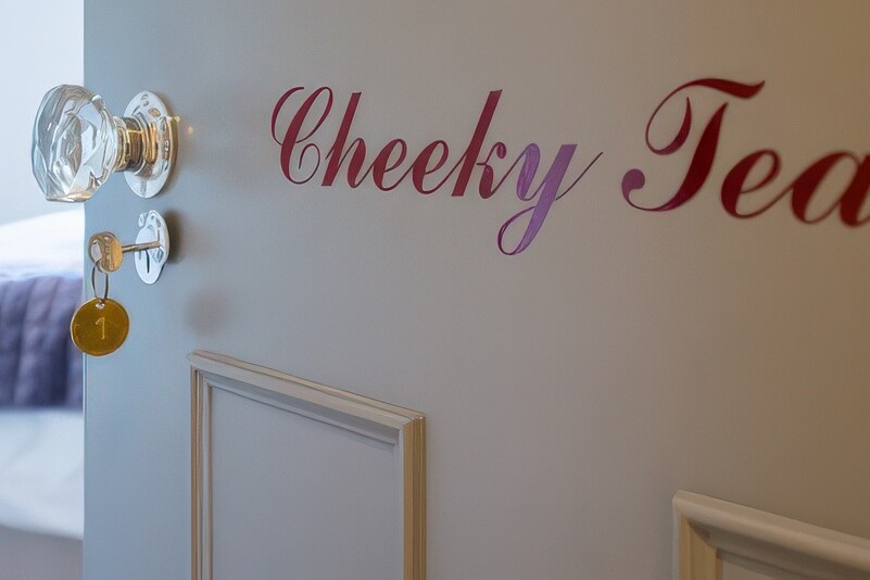 A door slightly ajar with the words 